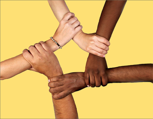 The picture shows the hands of women with all five different shades of skin grabbing each other's wrist to form the shape of a star and to indicate unity.
