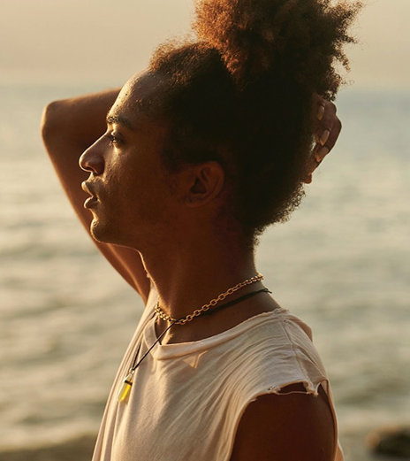 Romulo stands on the beach, and looks wondrously into the horizon. He seems to breathing in like he's at peace or releasing something.
